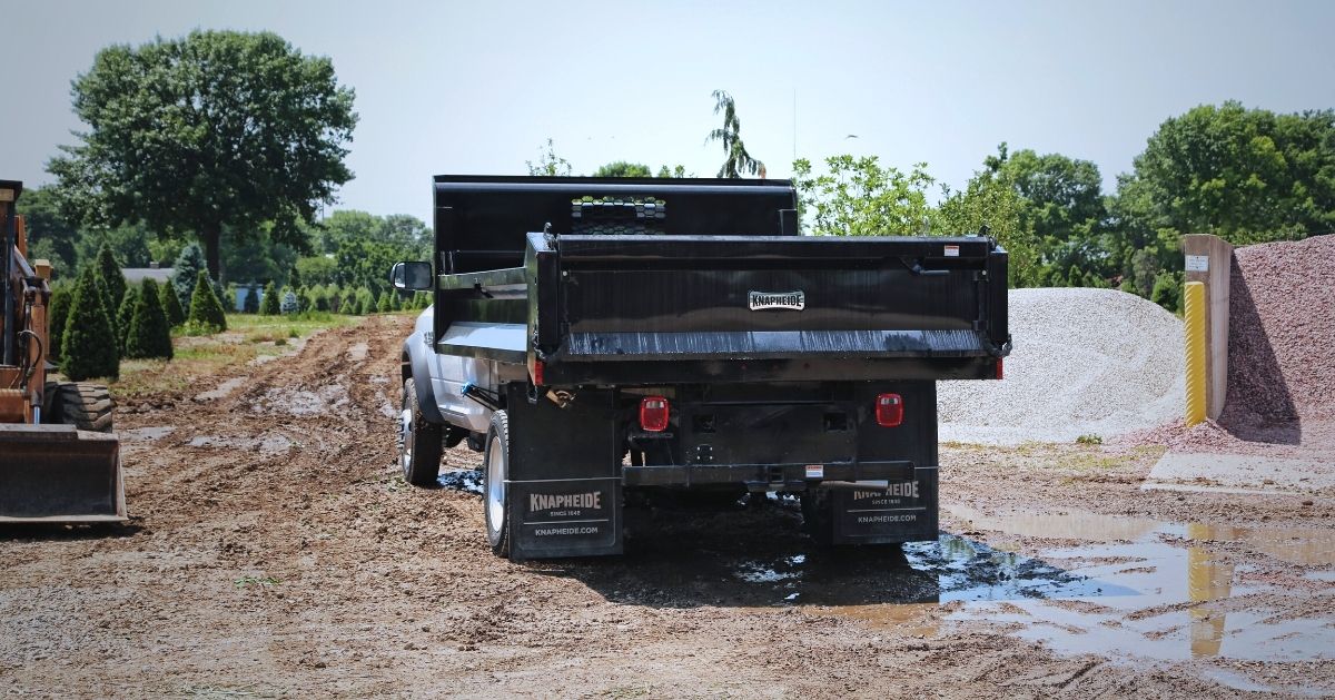 Truck with Knapheide dump body at job site